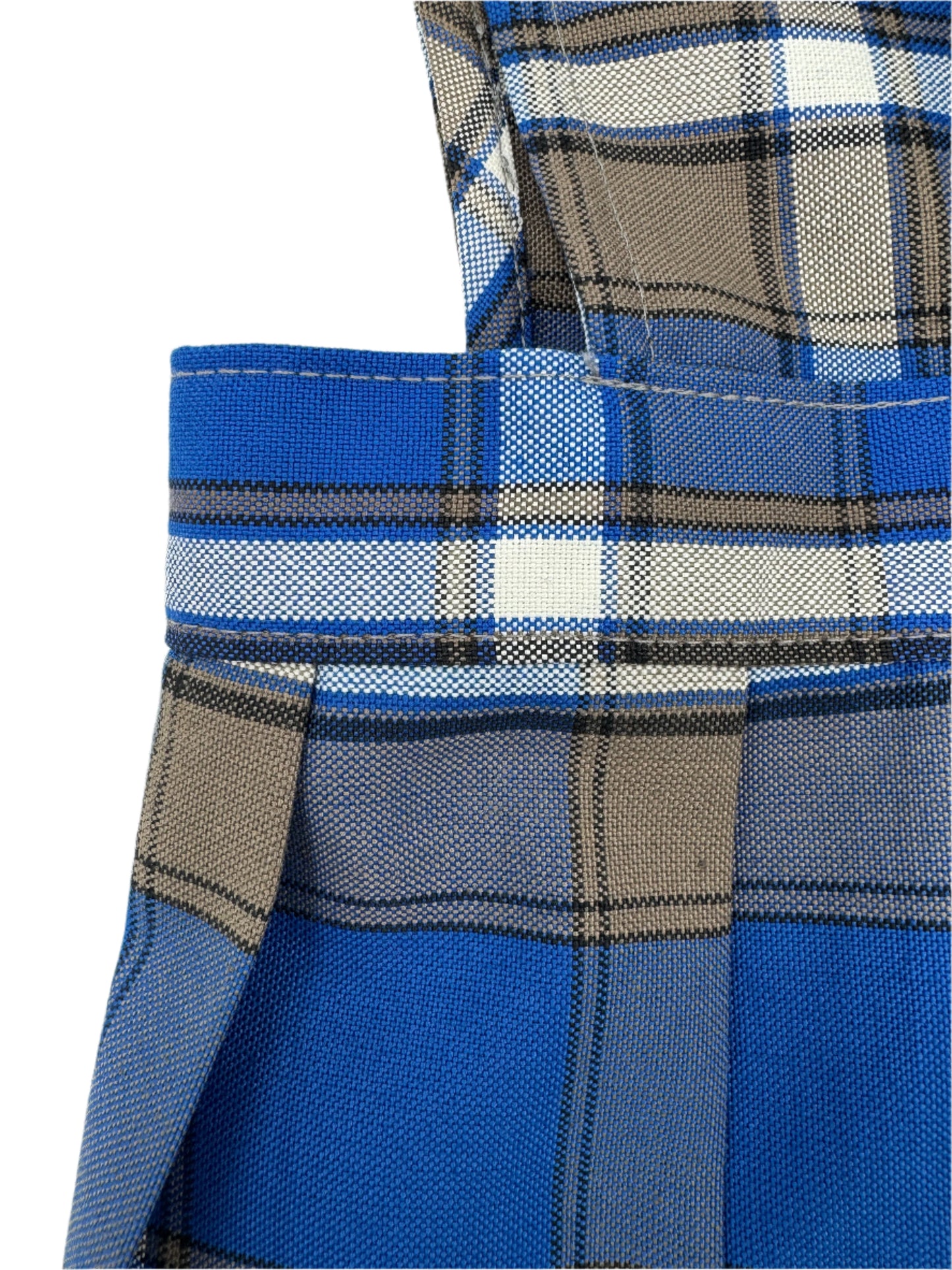 Close-up of a blue plaid fabric with a visible brand logo.