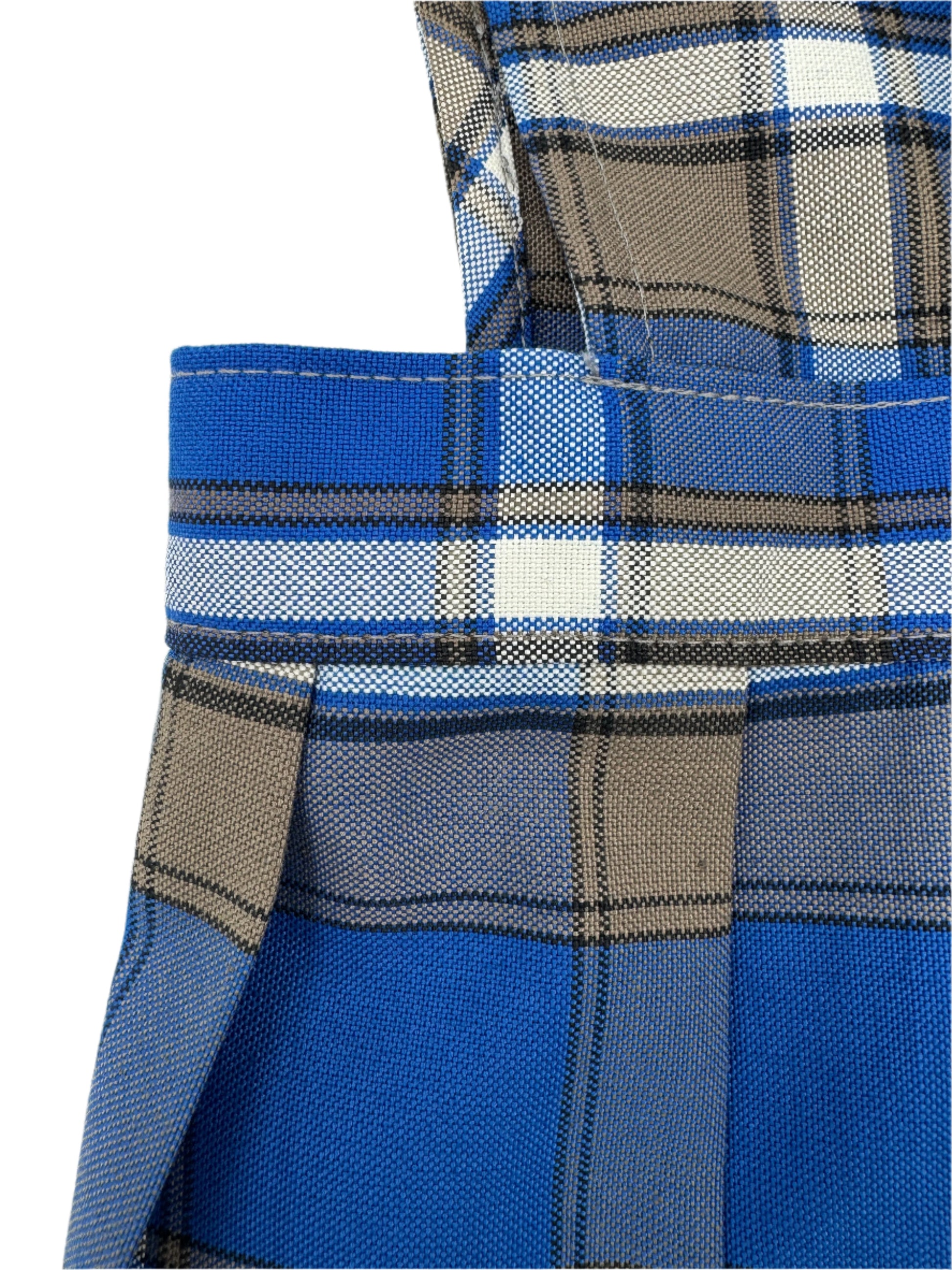 Close-up of a blue plaid fabric with a visible brand logo.