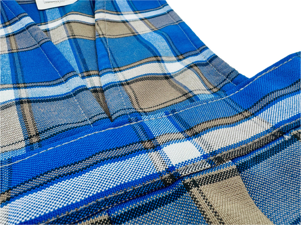 Close-up of blue plaid fabric with a white background